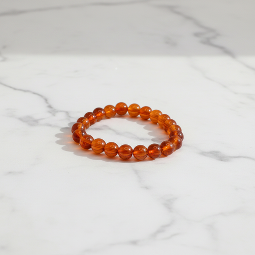 Amber Brown Beaded Bracelet white marble flat lay
