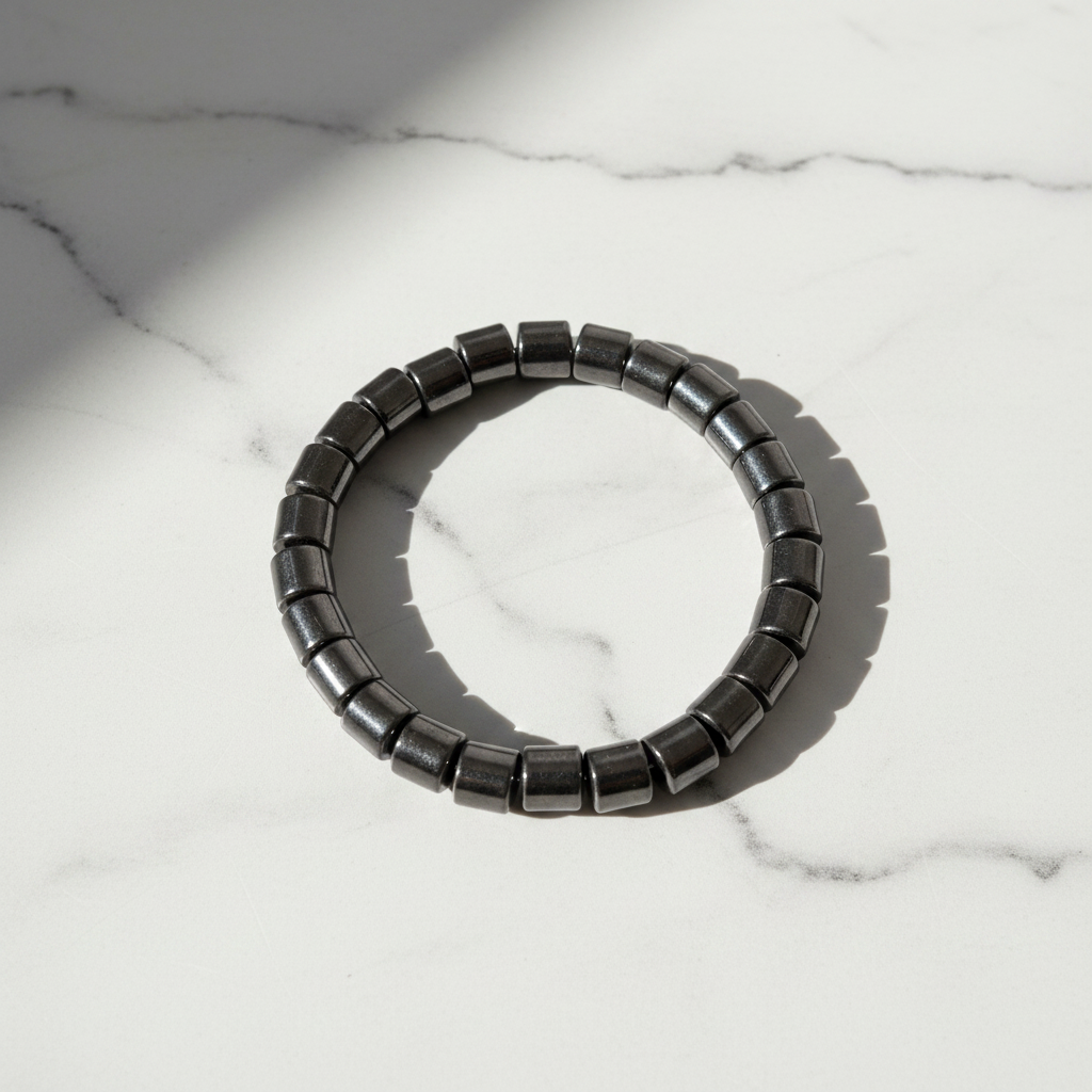 Hematite Cylinder Beaded Bracelet white marble flat lay